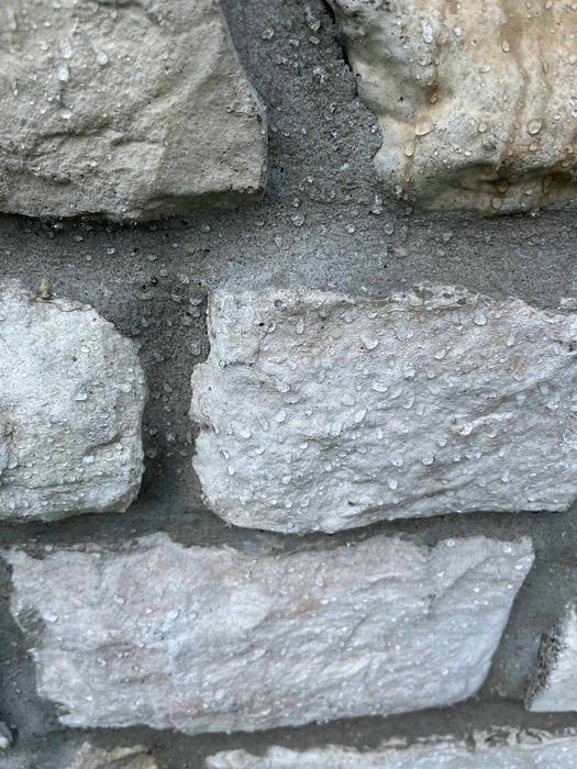 Close-up of a stone wall with gray stones