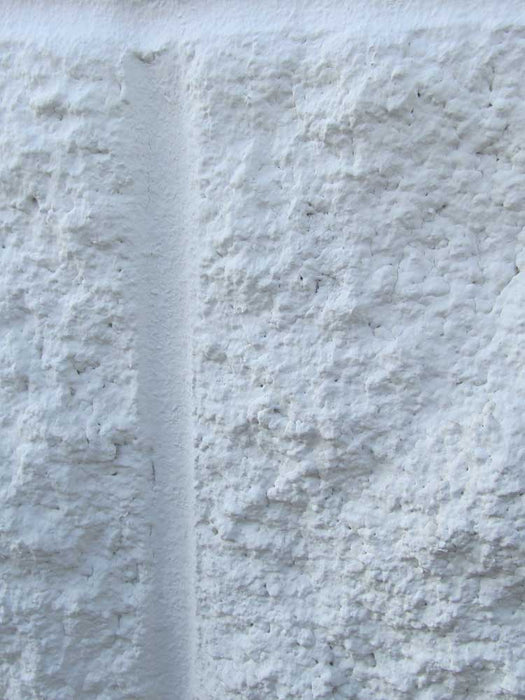 Close-up of a textured white stone surface