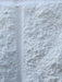 Close-up of a textured white stone surface