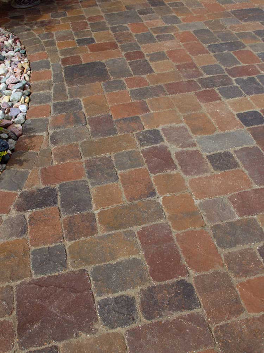 Patterned stone pavement with a variety of brown and gray colors.