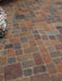 Patterned stone pavement with a variety of brown and gray colors.