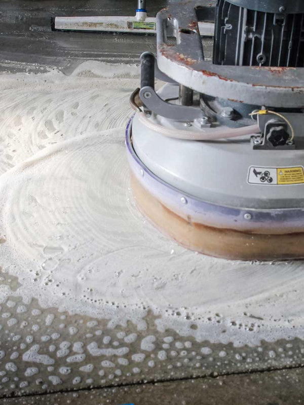 Floor polishing machine in action on a concrete floor