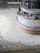 Floor polishing machine in action on a concrete floor
