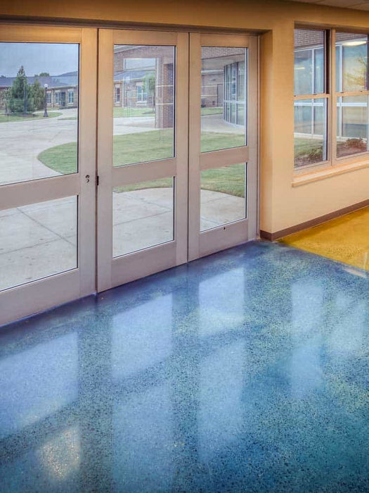Polished concrete floor with glass doors leading outside