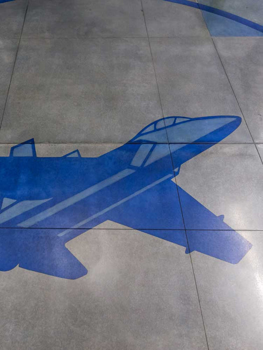 Blue airplane silhouette on a tiled floor