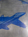 Blue airplane silhouette on a tiled floor