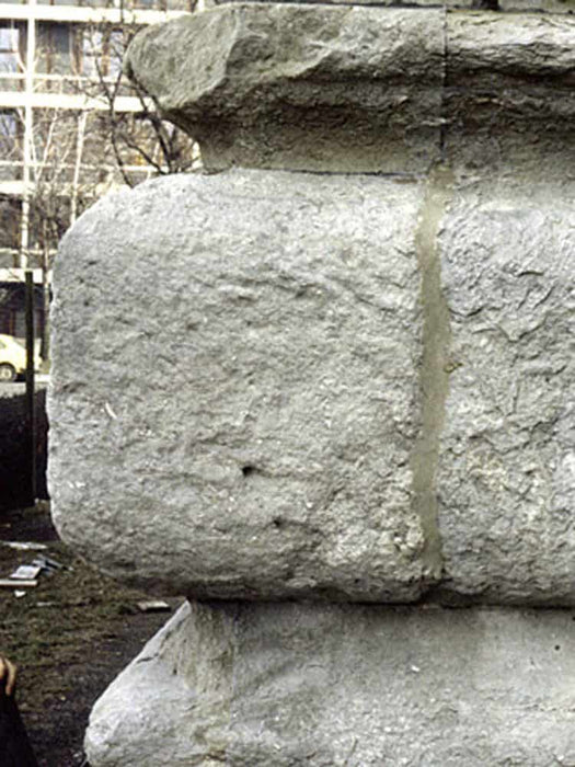 Close-up of a large stone block with visible texture and cracks.