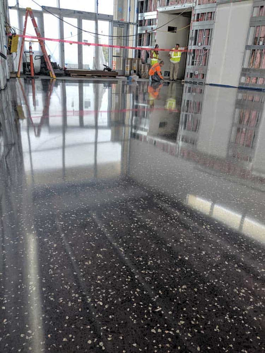 Integral color mixed into concrete overlay creating uniform colored polished concrete surface