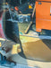 Person using a tool on a pipe with a toolbox in the background