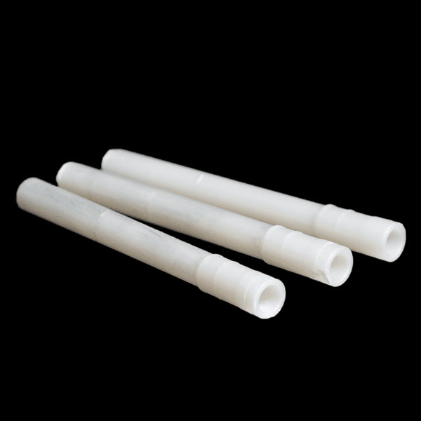 A set of white, cylindrical retrofit weep vents for brick walls.