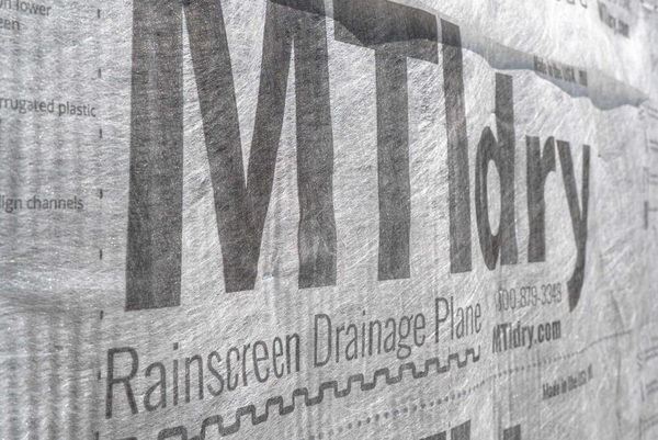 Close-up of a rainscreen drainage plane with 'MTI Dry' branding.