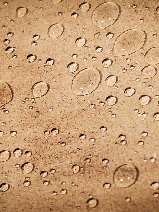 Brown surface with water droplets