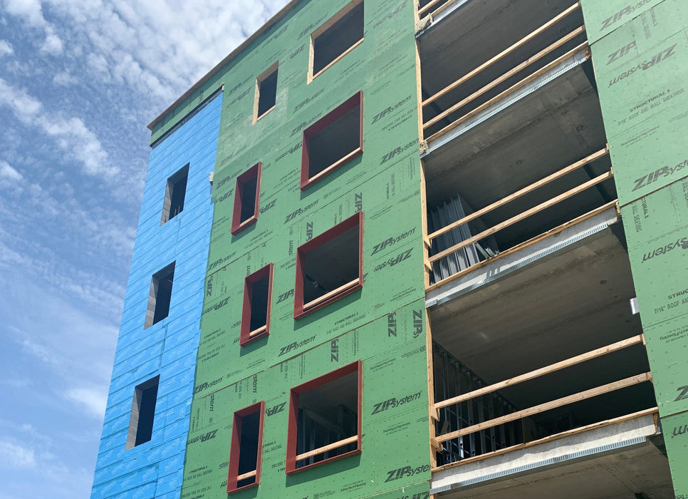 Building under construction with Z-Flex insulation on a blue sky background