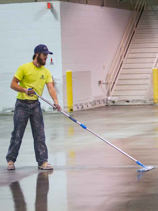 Person cleaning a floor with a mop in an indoor setting