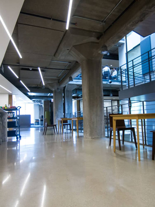 Modern indoor space with concrete pillars and tables