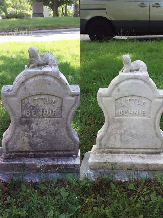 Two stone grave markers with engraved names on a grassy area.