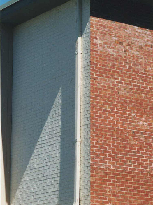 Close-up of a building with gray and red brick walls.