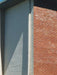 Close-up of a building with gray and red brick walls.