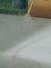 High-pressure water jet cleaning a surface with a focus on the nozzle and water spray.