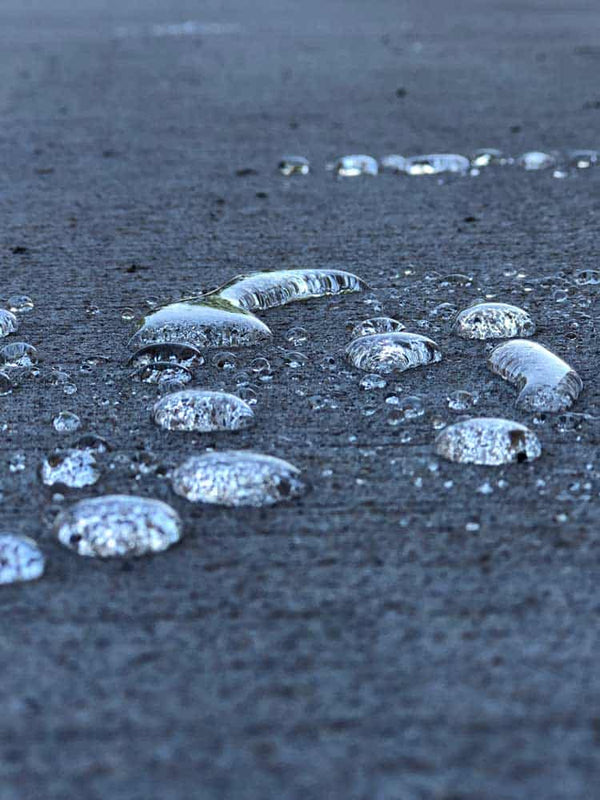 Ice-covered bubbles on a dark surface