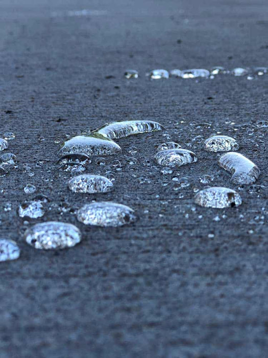 Ice-covered bubbles on a dark surface