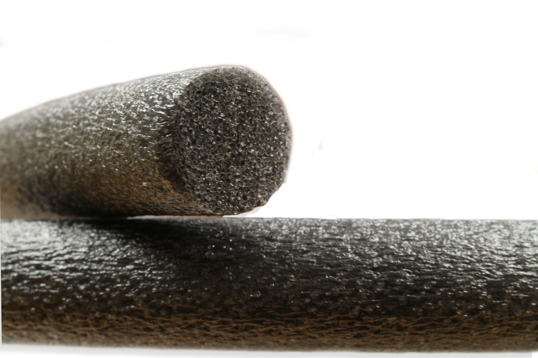 Two cylindrical black objects on a white background