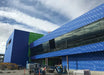 Installing Henry Blueskin VP160 self-adhered air barrier membrane on exterior wall sheathing