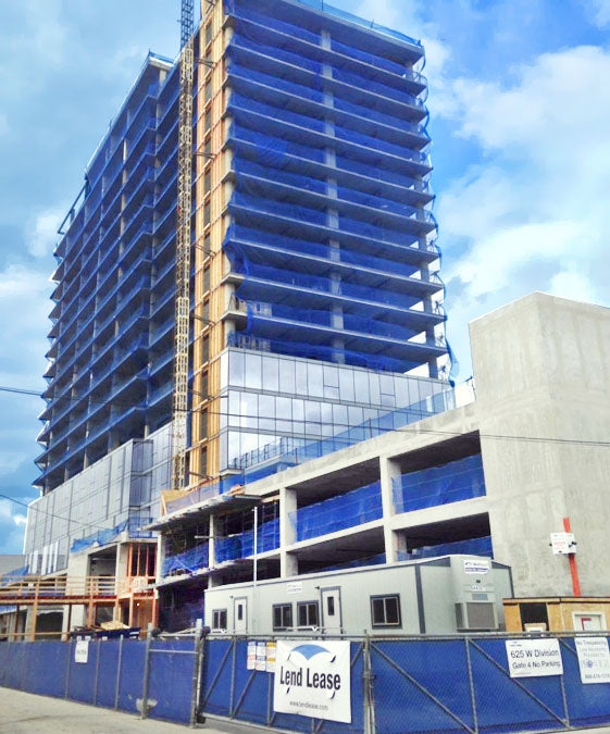 Construction debris netting installed on scaffolding to catch falling materials