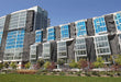 Construction mesh debris tarp providing wind control and shade protection on job sites