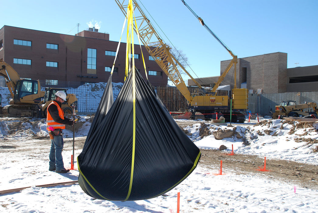 Construction snow removal tarp with four loops designed for lifting and removing snow from job sites