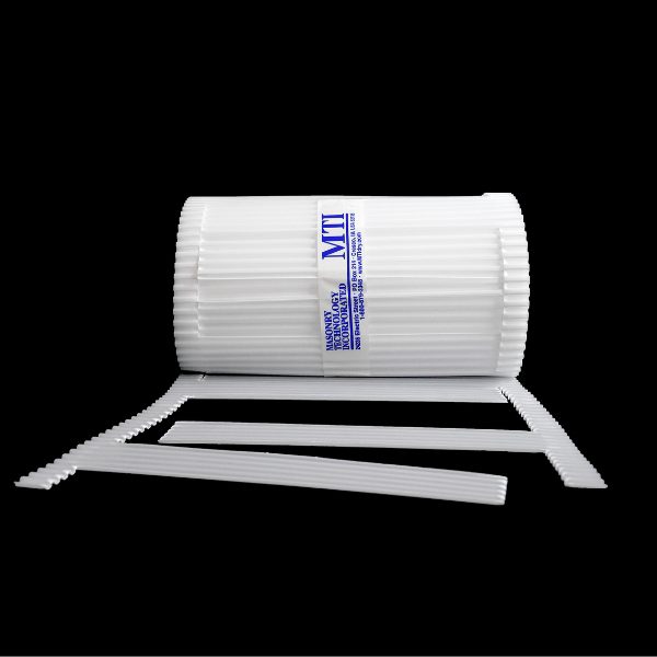 A roll of MTI Stone Cavity Weep, a white self-spaced weep for natural stone, with additional accessories lying beside it.