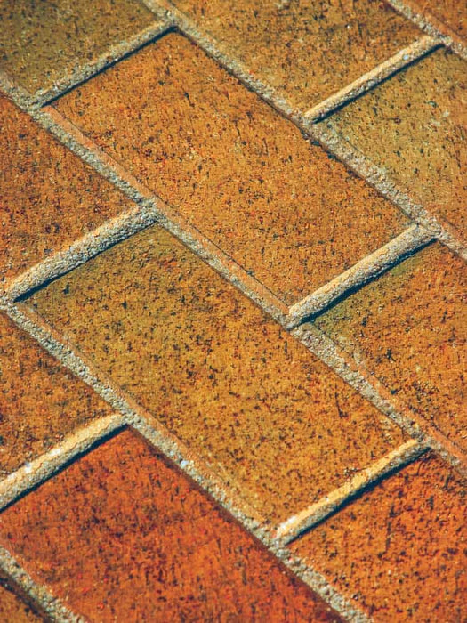 Close-up of patterned paving stones with a herringbone arrangement.