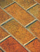 Close-up of patterned paving stones with a herringbone arrangement.