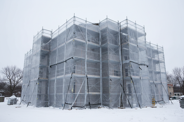 WINTER JOB SITE WRAPPED IN REINFORCED POLY SHEETING